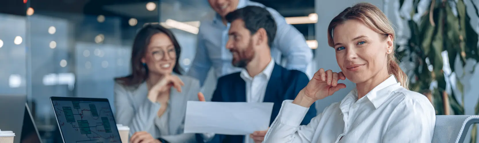 smiling-confident-businesswoman-sitting-meeting-office-with-her-colleagues-background.jpg