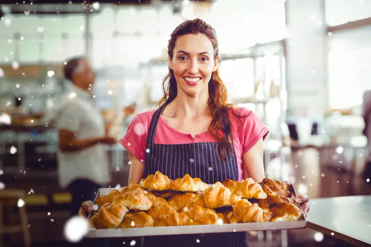 woman-smiling-with-tray-of-croissants-in-bakery.jpg