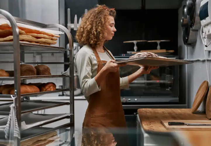 female-baker-preparing-fresh-bread.jpg