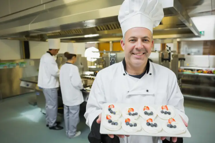 chef-showcasing-desserts-in-commercial-kitchen.jpg