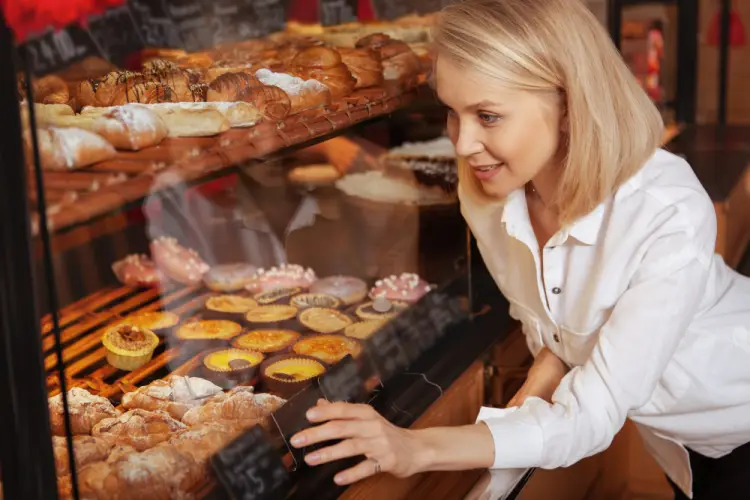 woman-admiring-bakery-display-pastries.jpg