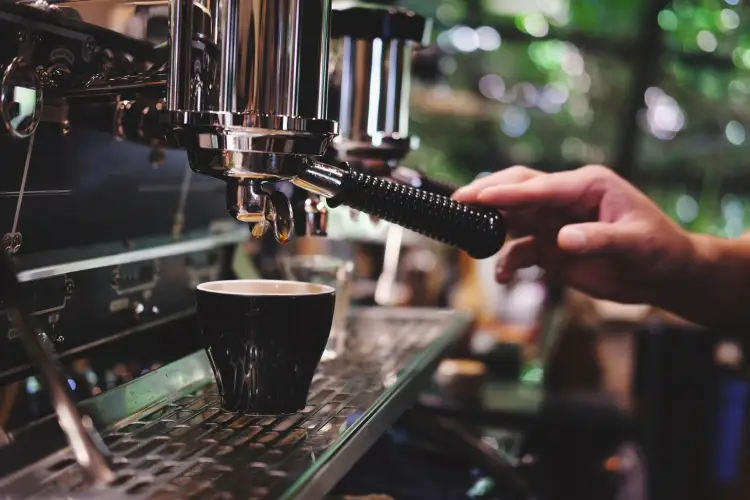 cropped-hand-touching-handle-espresso-maker-cafe.jpg