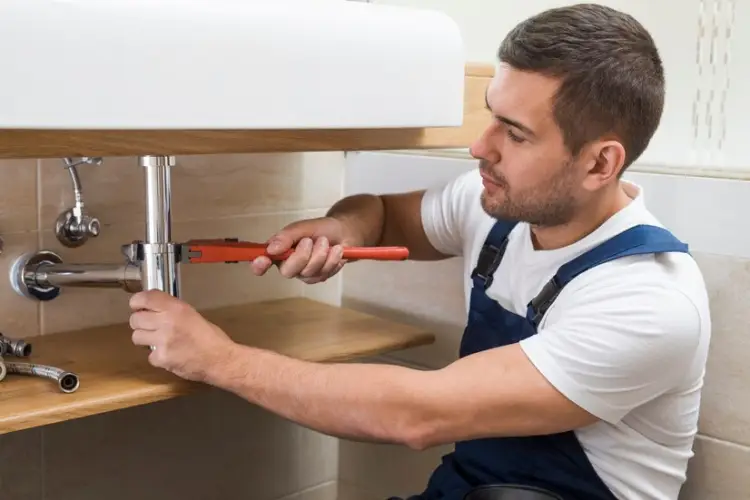 sanitary-technician-using-wrench-sink_23-2147772326.jpg