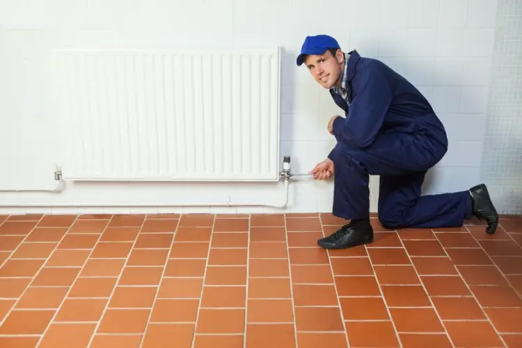 handyman-blue-boiler-suit-repairing-radiator-smiling-camera_13339-85096.jpg
