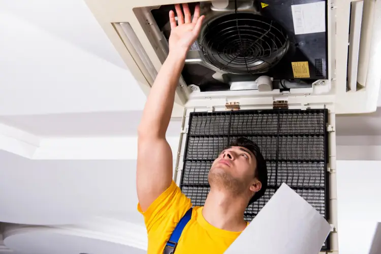 hvac-technician-inspecting-ceiling-unit.jpg