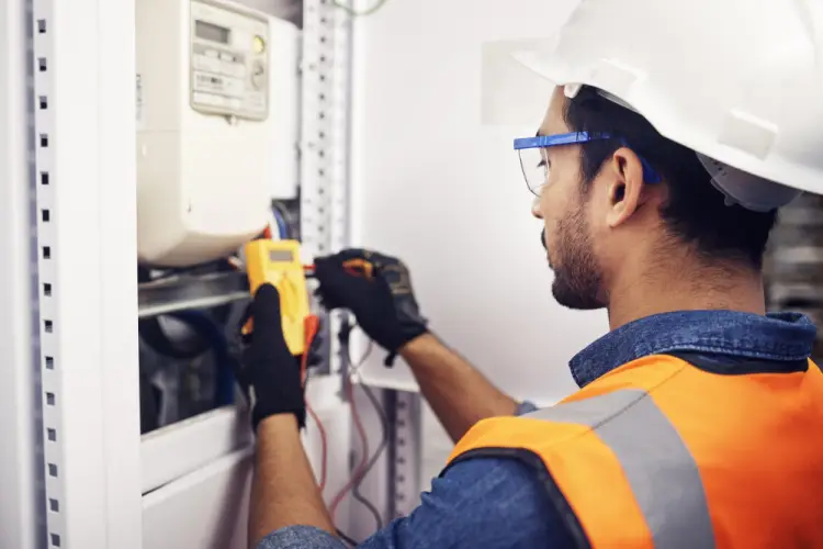 technician-using-multimeter-electrical-panel.jpg