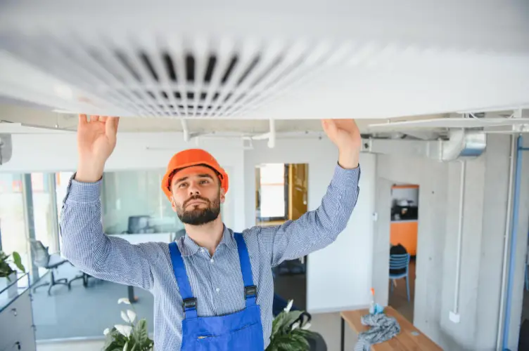 hvac-technician-inspecting-duct-system.jpg