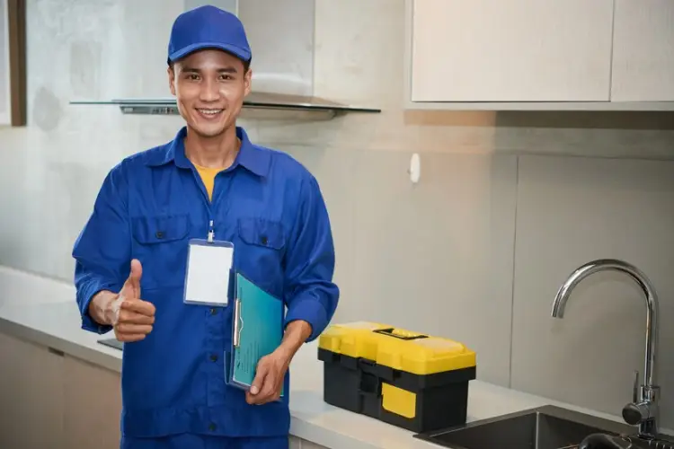 cheerful-asian-plumber-standing-near-kitchen-sink-showing-thumb-up_1098-17826.jpg