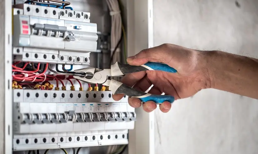 electrical-technician-working-switchboard-with-fuses_169016-5512.jpg