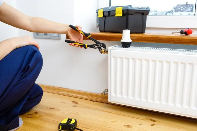 repair-heating-radiator-closeup-woman-repairing-radiator-with-wrench_93200-5707.jpg