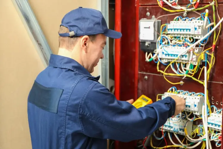 electrician-measuring-voltage-distribution-board_392895-106342.jpg