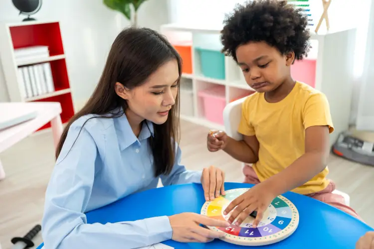 preschool-teacher-helping-child-with-educational-game.jpg