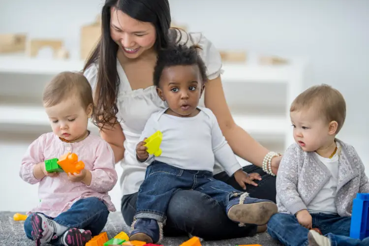 babies-playing-with-caregiver-in-childcare-center.jpg