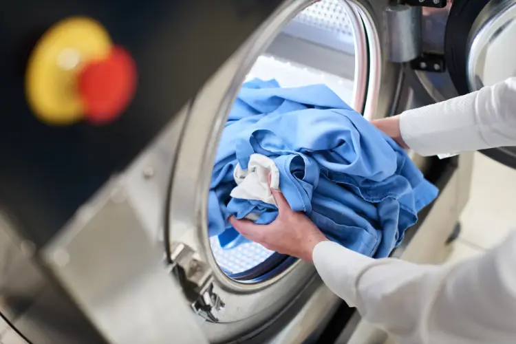 loading-blue-uniforms-into-industrial-washer.jpg