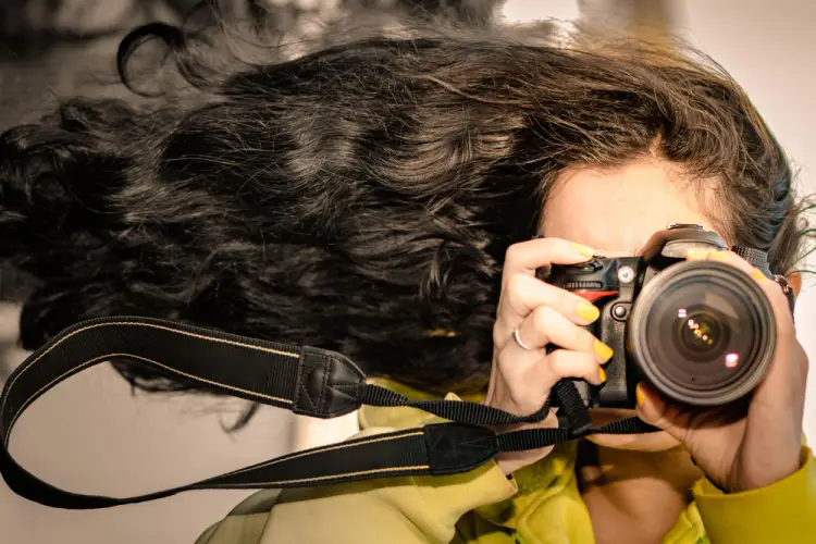 windblown-female-photographer-yellow-coat.jpg