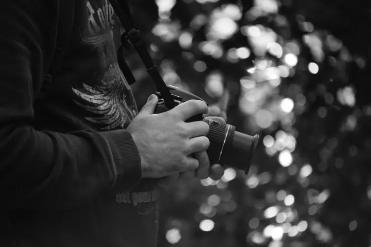 black-white-photo-man-holding-camera.jpg