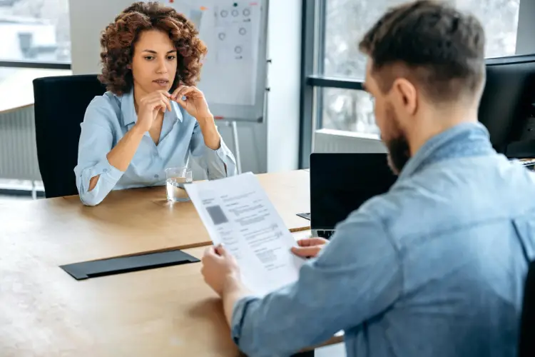 interviewer-reviewing-resume-of-woman.jpg