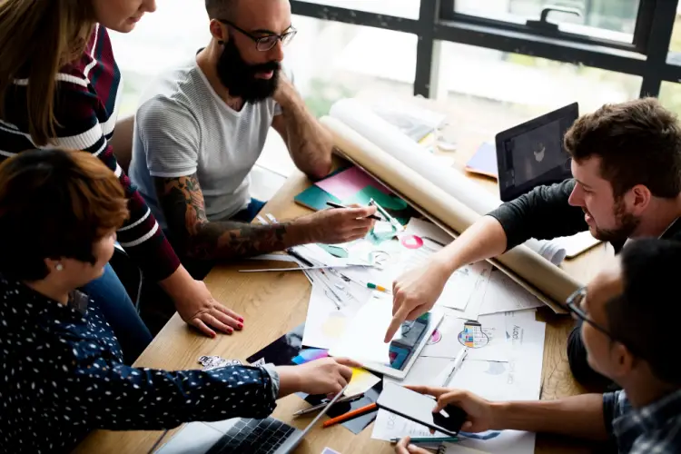 diverse-team-working-on-design-project-table.jpg