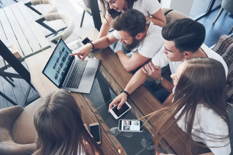 group-reviewing-media-content-on-laptop-together.jpg