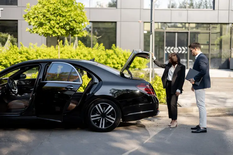 businessman-female-chauffeur-near-car-outdoors.jpg