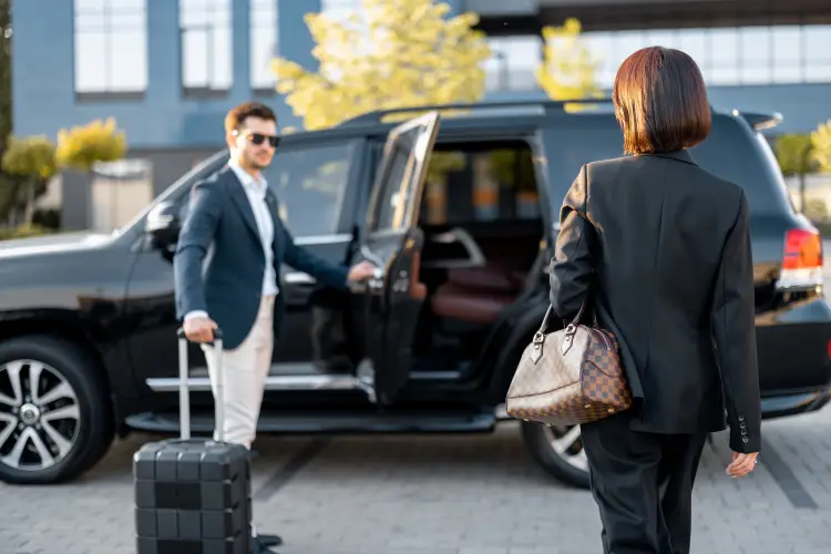 elegant-business-woman-walks-luxury-car-man-with-suitcase-opens-vehicle-door-letting-lady-concept-business-trip-travel.jpg