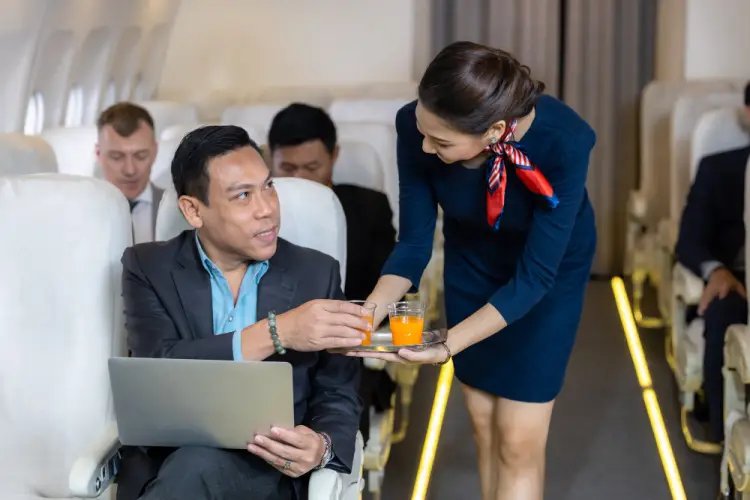 flight-attendant-serving-drinks-to-passenger.jpg