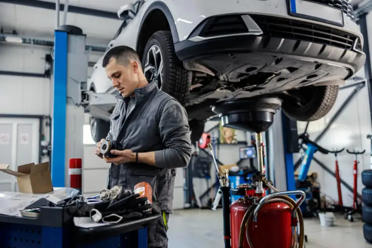 auto-mechanic-performing-oil-change.jpg