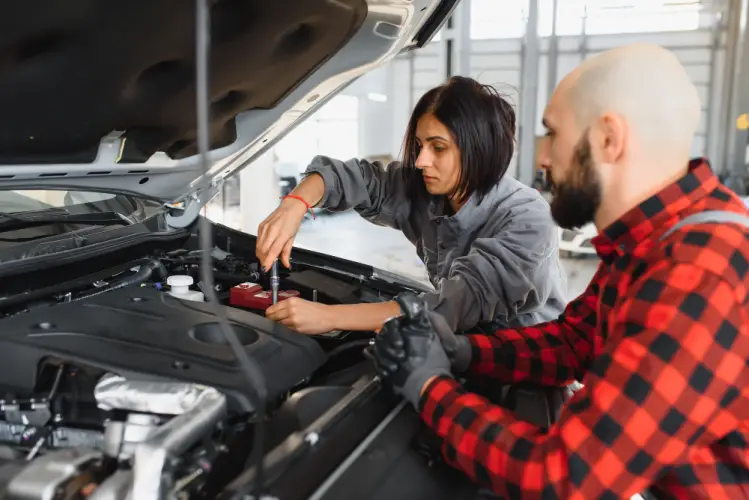 female-auto-technician-teaching-male-mechanic-car-engine.jpg