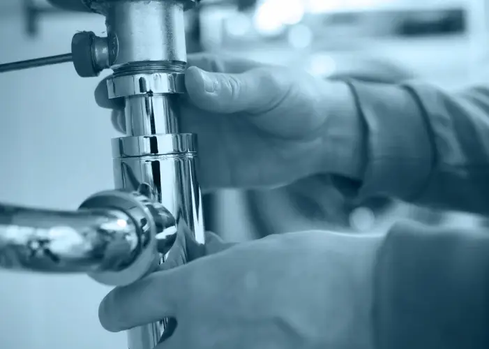 plumber-installing-chrome-pipe-under-sink.jpg