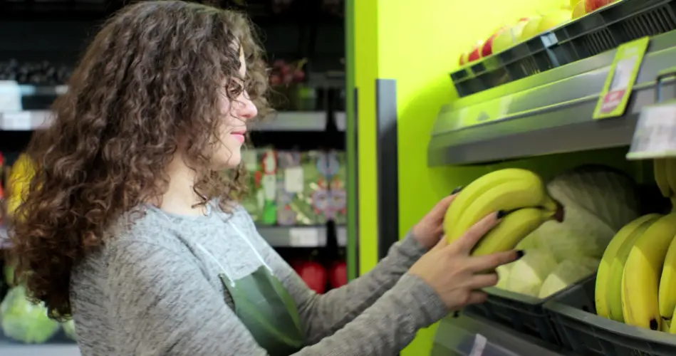 woman-picking-bananas-at-supermarket.jpg