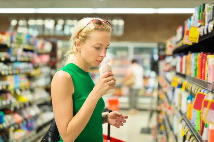woman-smelling-product-in-grocery-aisle.jpg