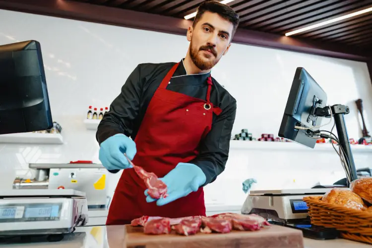 young-butcher-preparing-meat-for-sale.jpg