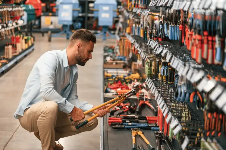orange-colored-wire-cutter-holding-hands-man-is-hardware-shop.jpg