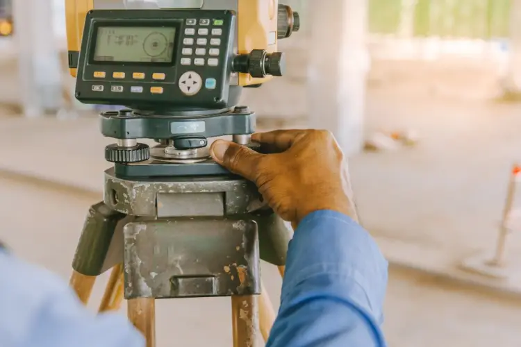 engineer-adjusting-survey-equipment-on-site.jpg