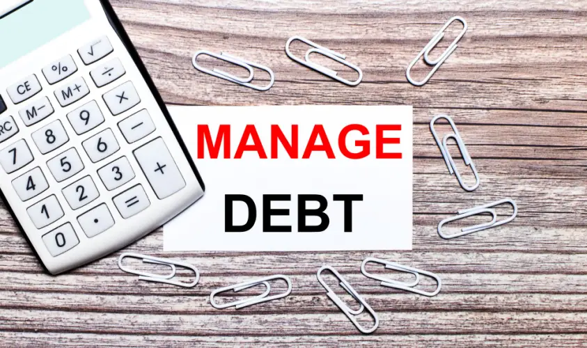 manage-debt-note-with-calculator-on-desk.jpg