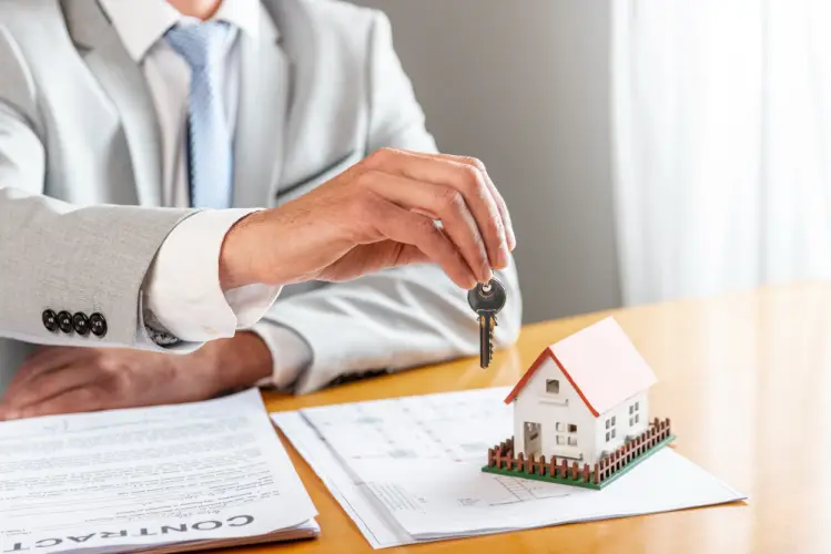 real-estate-agent-handing-keys.jpg
