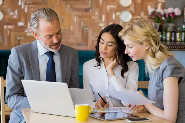 team-reviewing-financial-documents-laptop.jpg