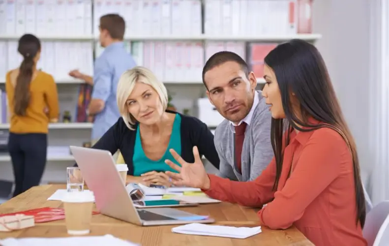 business-meeting-around-laptop-in-office.jpg
