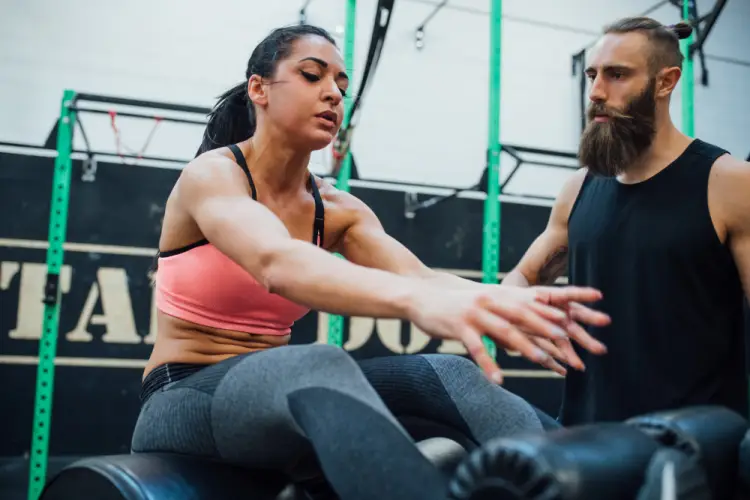 female-athlete-doing-core-training-with-trainer.jpg