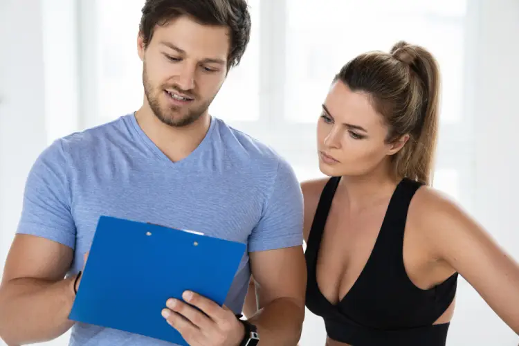 fitness-coach-reviewing-workout-plan-with-client.jpg