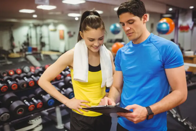 gym-trainer-discussing-plan-with-female-client.jpg