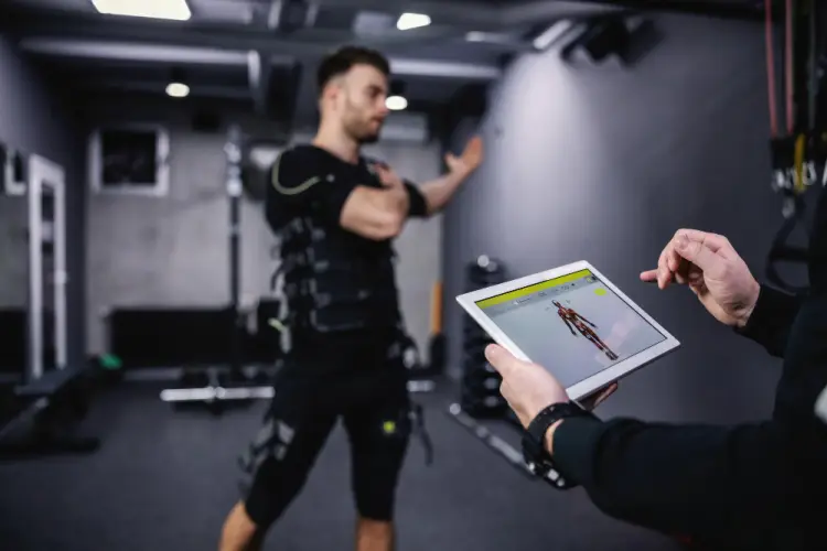 personal-trainer-using-digital-muscle-analysis.jpg