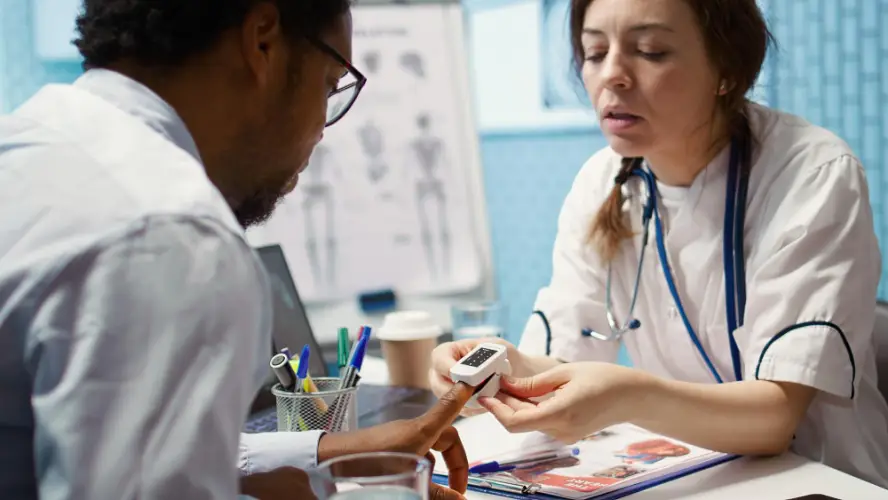 doctor-using-fingertip-pulse-oximeter.jpg