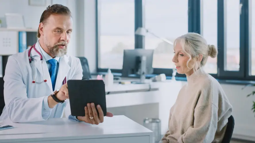 doctor-showing-tablet-to-older-woman.jpg