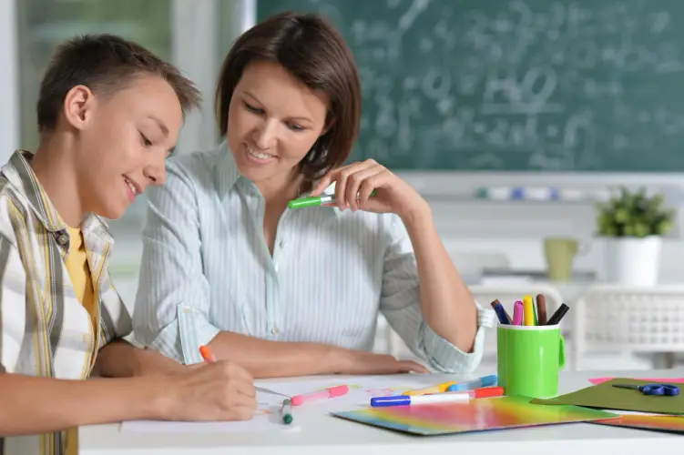 teacher-assisting-boy-homework.jpg