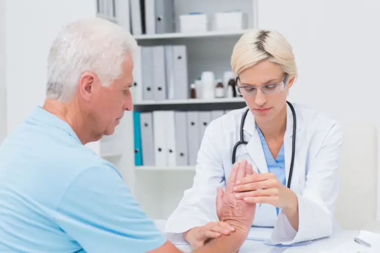 doctor-checking-elderly-mans-hand.jpg