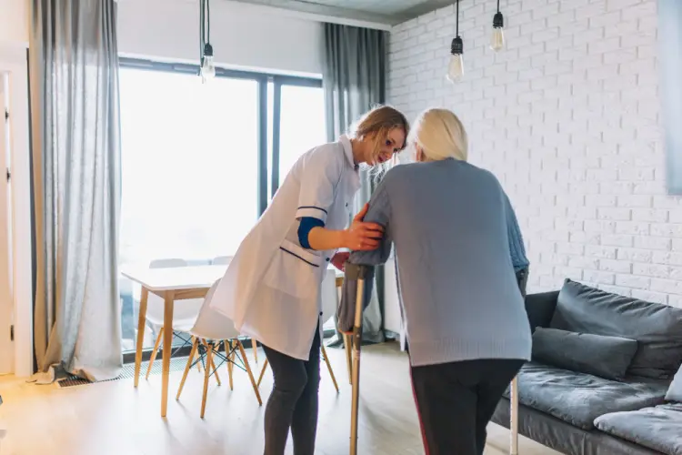 nurse-aid-helping-elderly-woman-at-home.jpg
