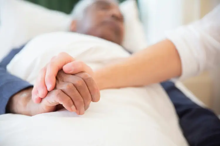 elderly-patient-holding-hands-hospice-care.jpg