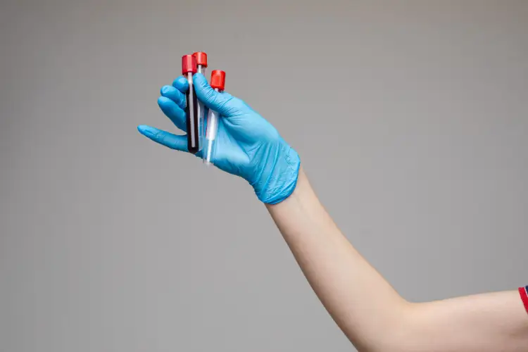 hand-holding-blood-collection-vials.jpg