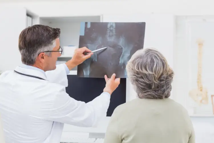 orthopedic-surgeon-explaining-hip-xray-to-patient.jpg